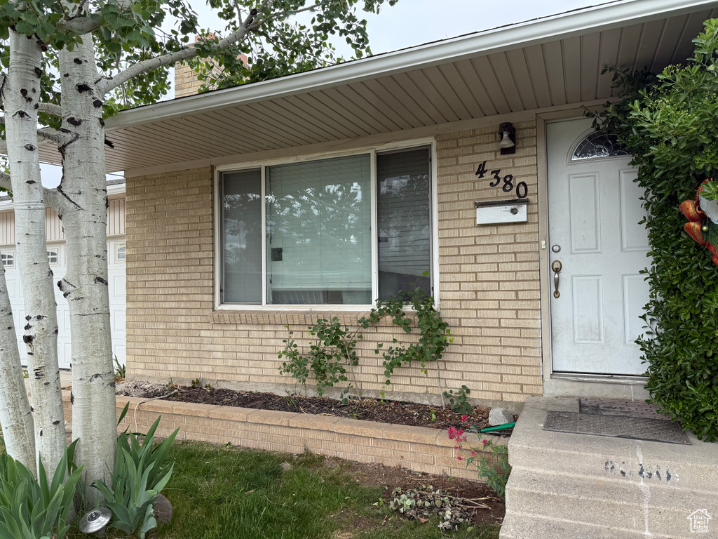 Property entrance featuring brick siding