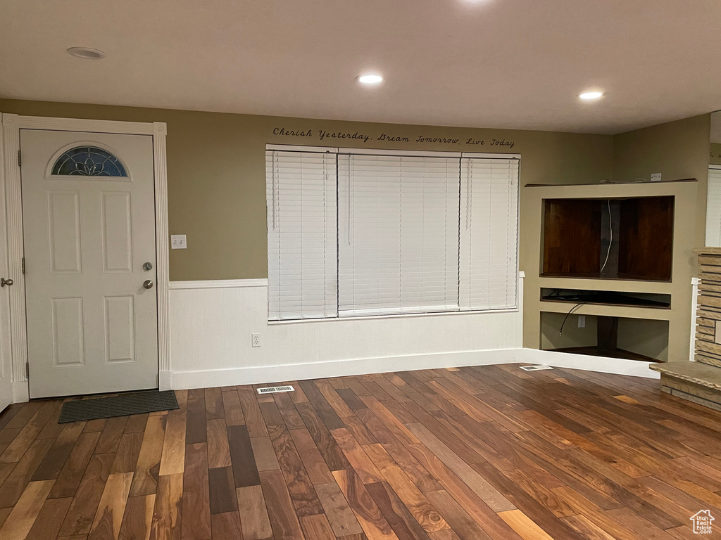 Entryway featuring wood finished floors, wainscoting, and recessed lighting