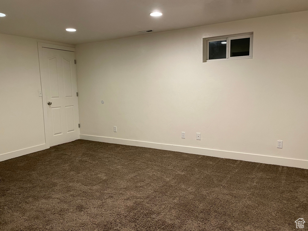 Finished basement featuring dark carpet, recessed lighting, and baseboards