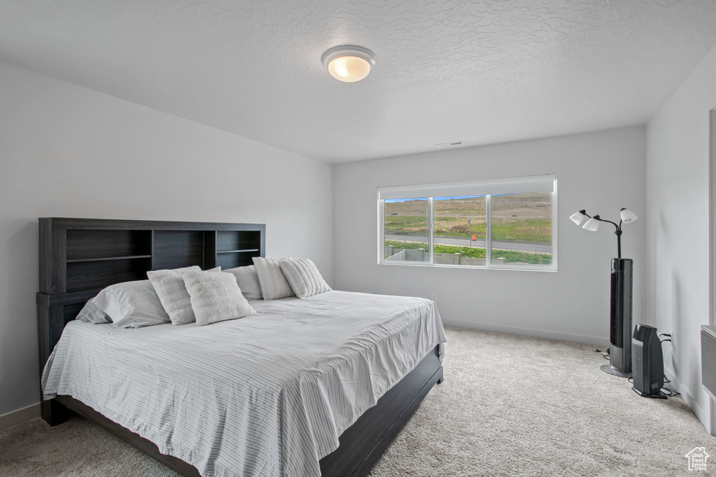 Carpeted bedroom with baseboards
