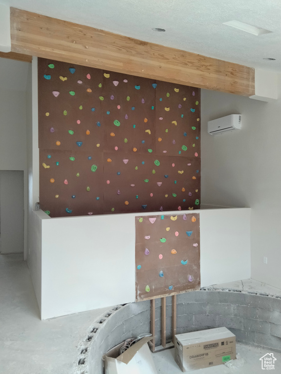 Interior space featuring concrete floors and wallpapered walls