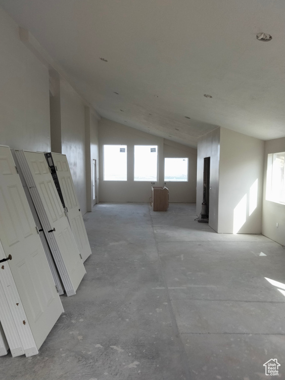 Unfurnished room featuring lofted ceiling