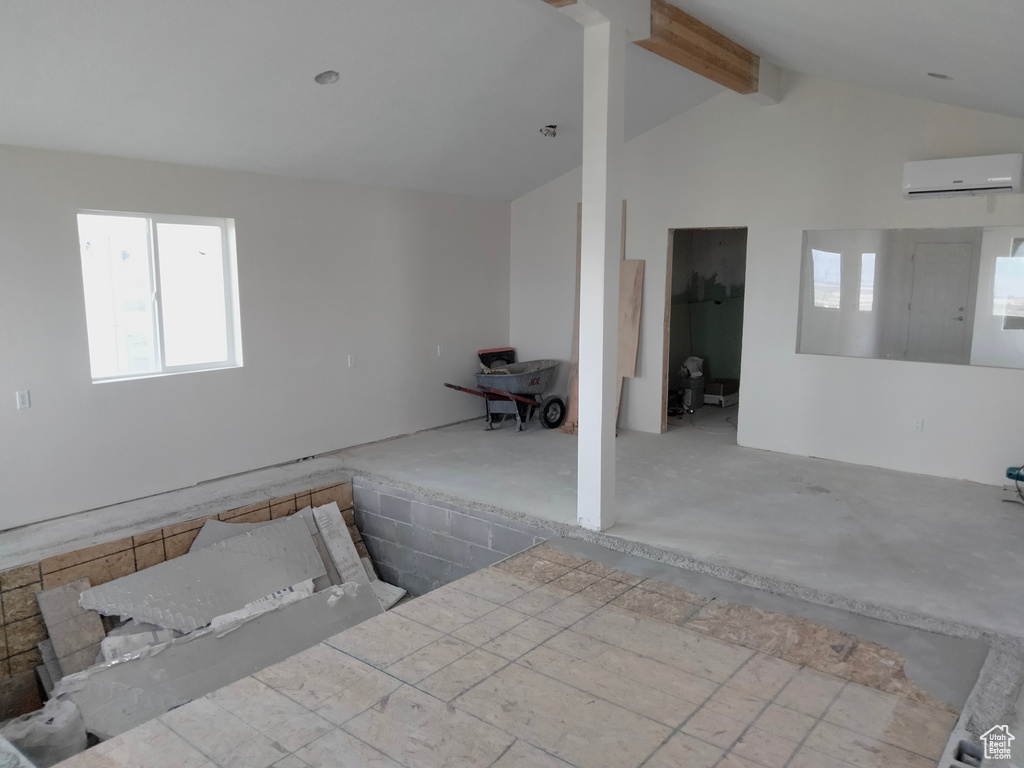 Unfurnished room featuring a wall unit AC