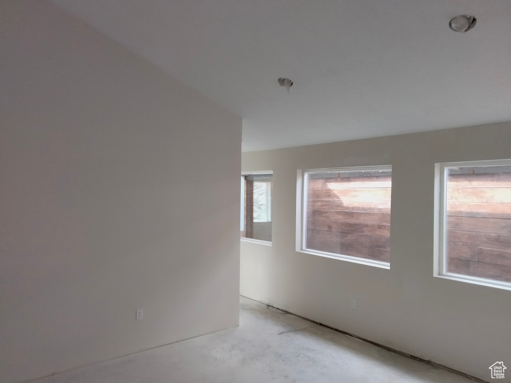 Unfurnished room with concrete flooring