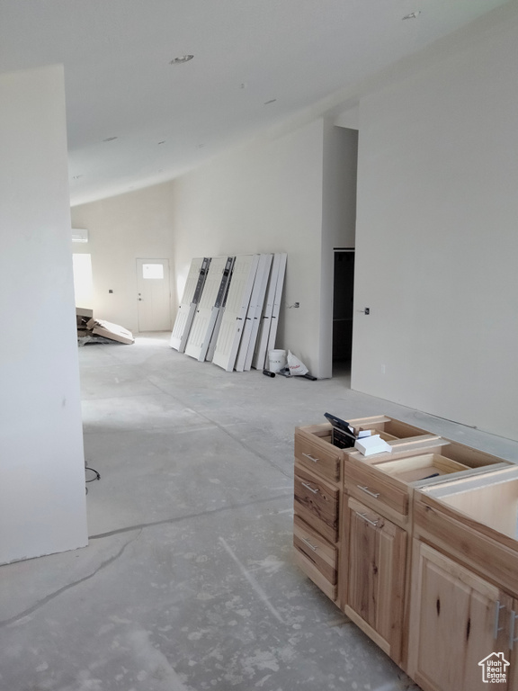 Unfurnished living room featuring concrete floors