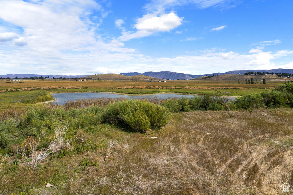 View of mountain background with a large body of water and rural landscape