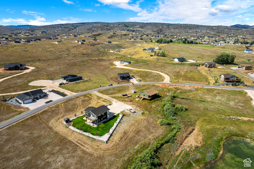 Aerial overview of property's location with a mountainous background and rural landscape