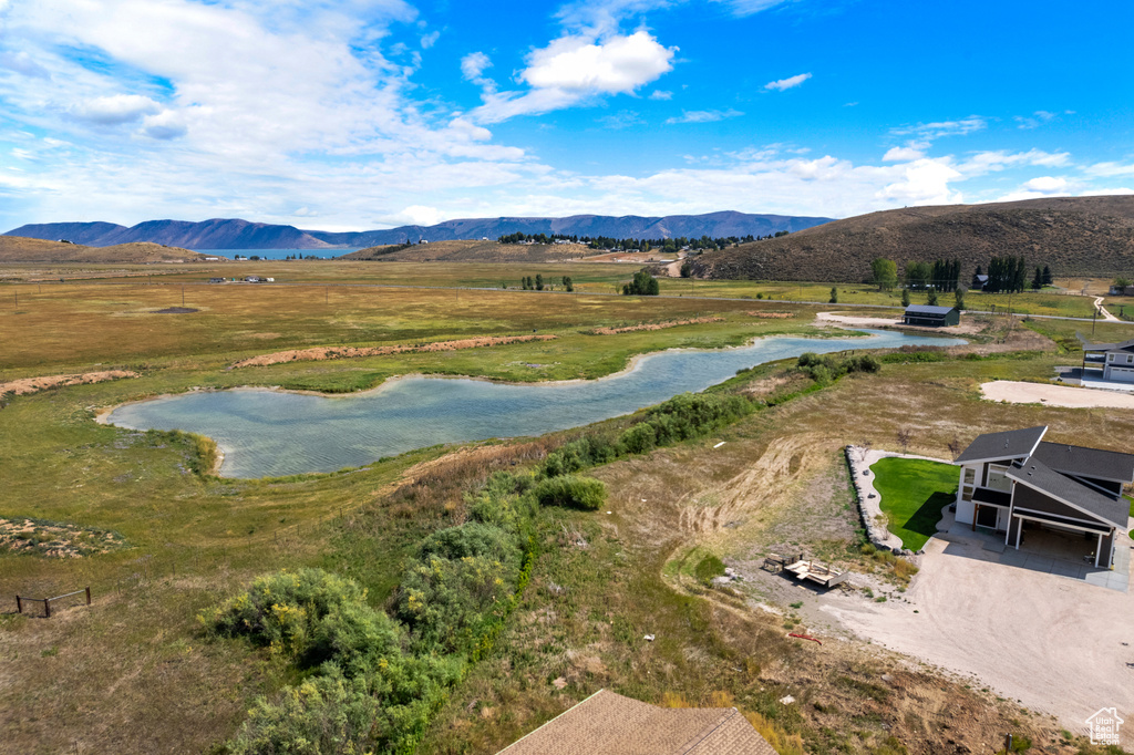 Aerial view of sparsely populated area featuring a water and mountain view