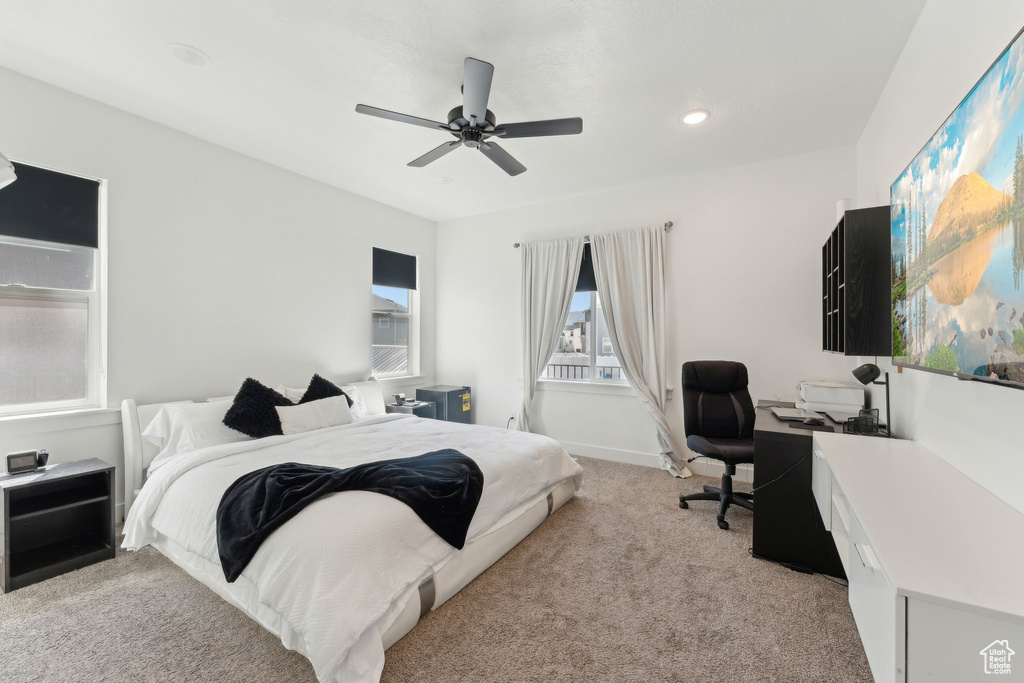 Bedroom featuring light carpet, an office area, ceiling fan, and recessed lighting