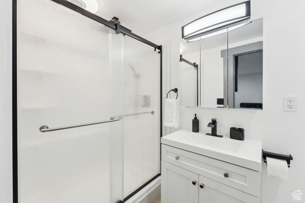 Bathroom with vanity and a shower stall