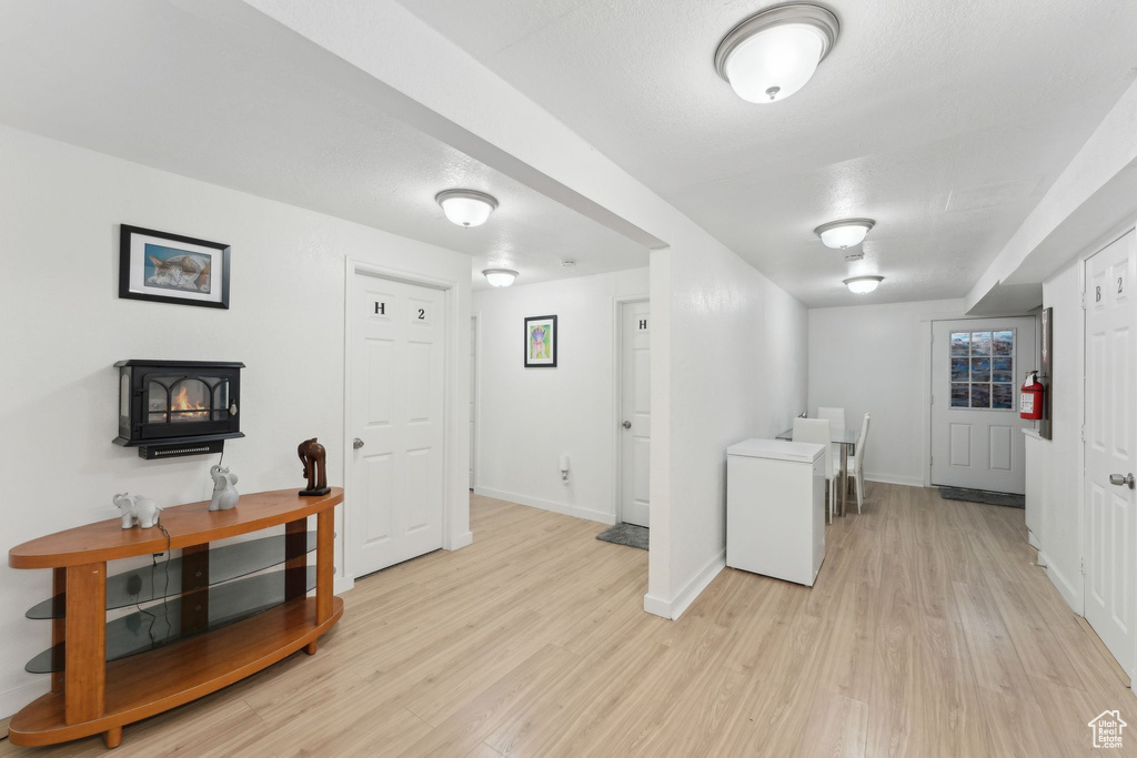 Laundry room with light wood-style flooring and baseboards
