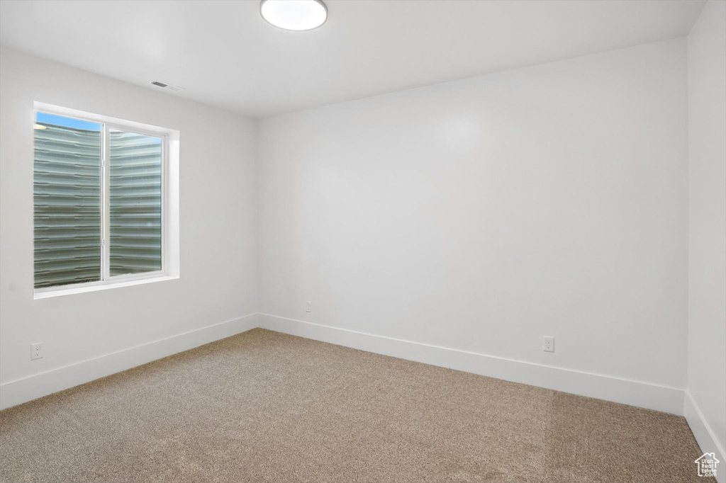 Empty room with light colored carpet