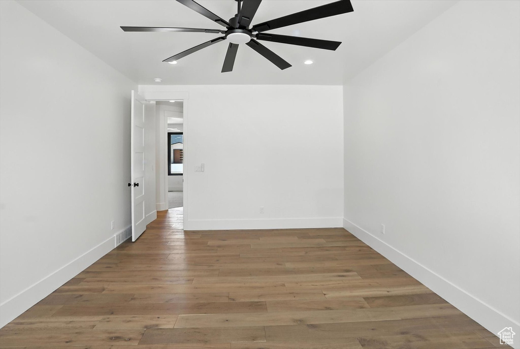 Spare room with ceiling fan, light wood finished floors, and recessed lighting