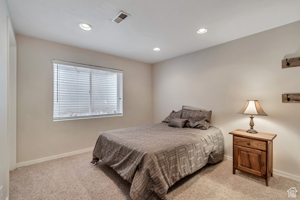 Bedroom with light carpet, baseboards, and recessed lighting
