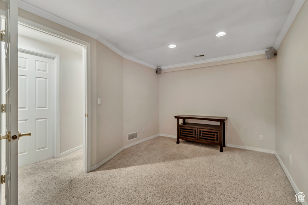 Empty room with carpet flooring, ornamental molding, recessed lighting, and baseboards