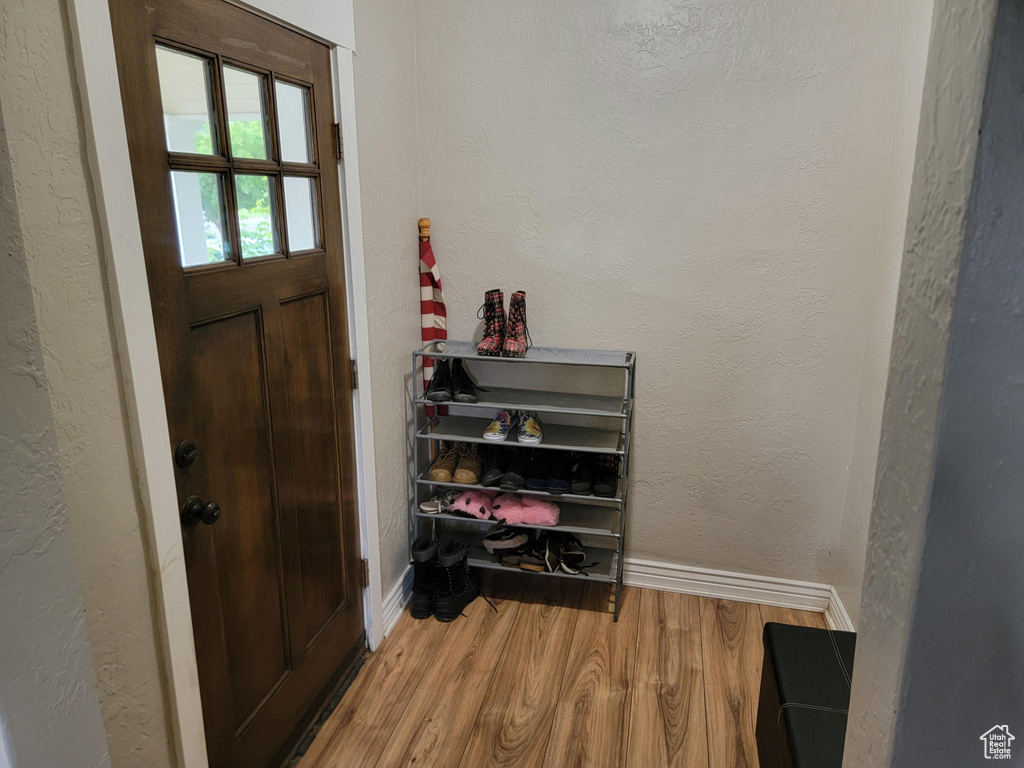 Entryway featuring wood finished floors and baseboards