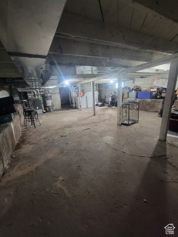 Unfinished basement with washer / dryer and water heater