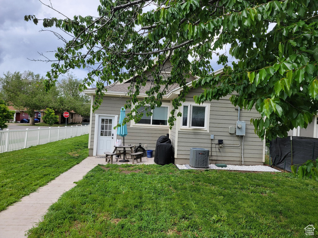 Rear view of property featuring central AC and a patio