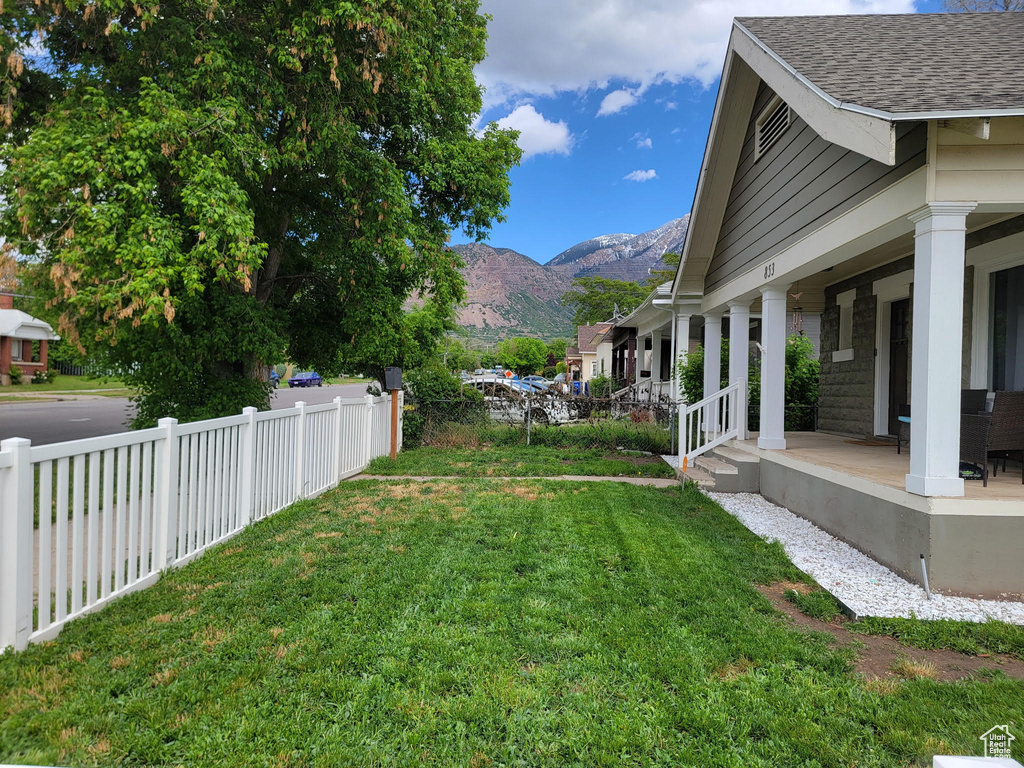View of yard featuring a mountain view and a porch