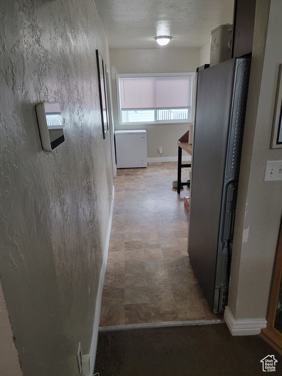 Corridor featuring baseboards