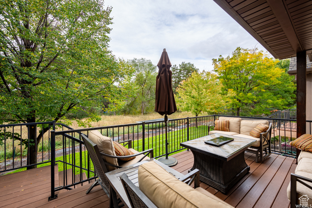Deck with an outdoor living space with a fire pit