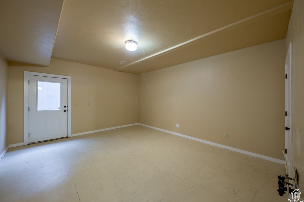 Empty room with concrete floors and baseboards