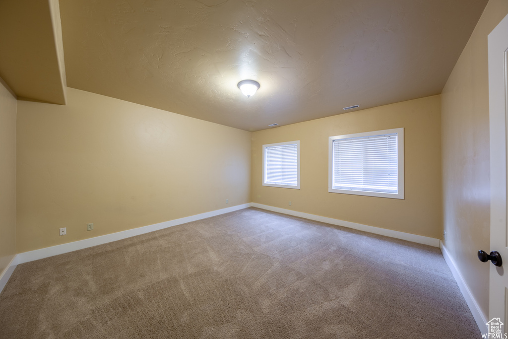 Spare room with baseboards and carpet flooring