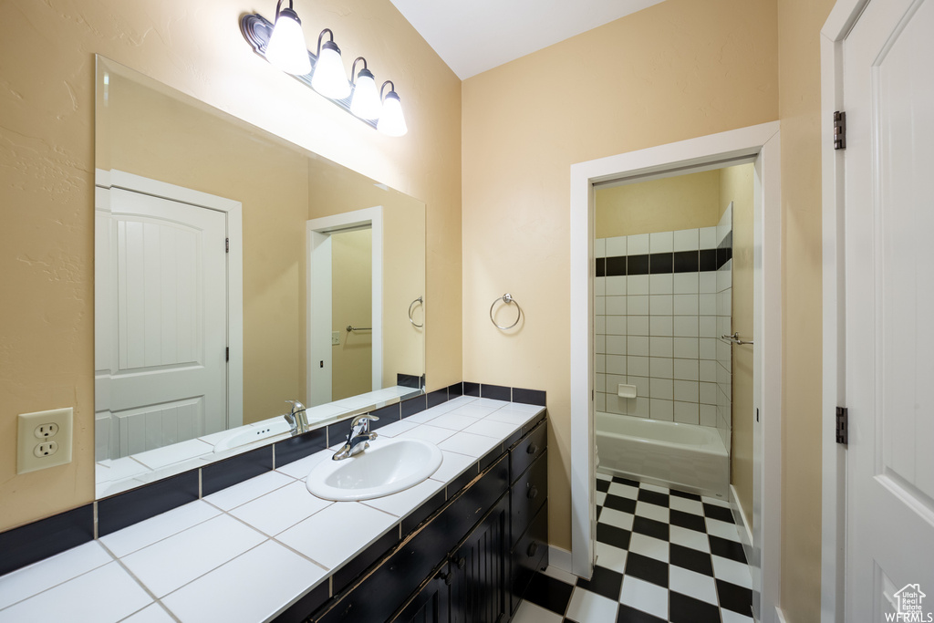 Bathroom with tile patterned floors and vanity