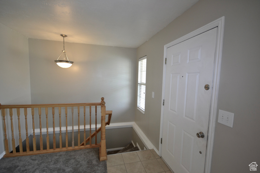 Entrance foyer featuring tile patterned flooring and baseboards