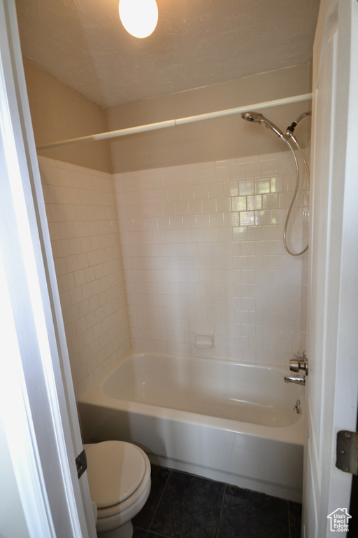 Bathroom with tile patterned flooring, toilet, and bathtub / shower combination