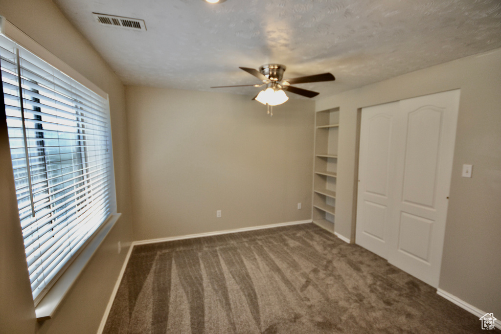 Unfurnished bedroom with multiple windows, baseboards, a closet, and carpet floors