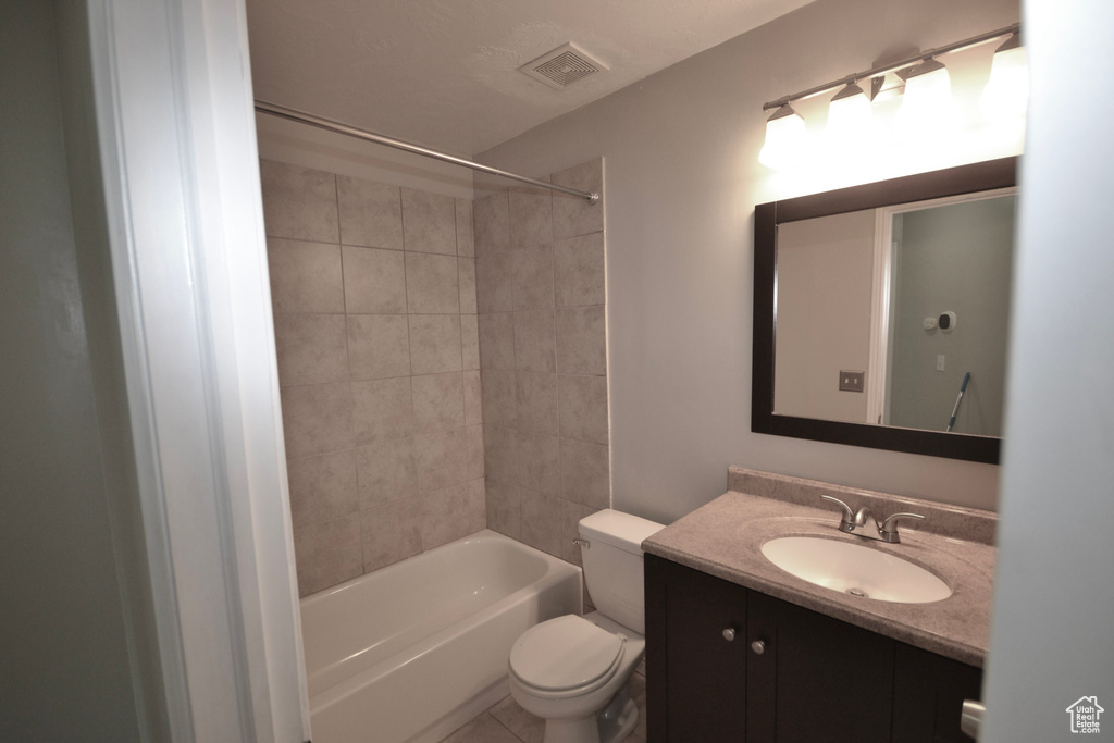 Bathroom with toilet, vanity, and shower / bathtub combination