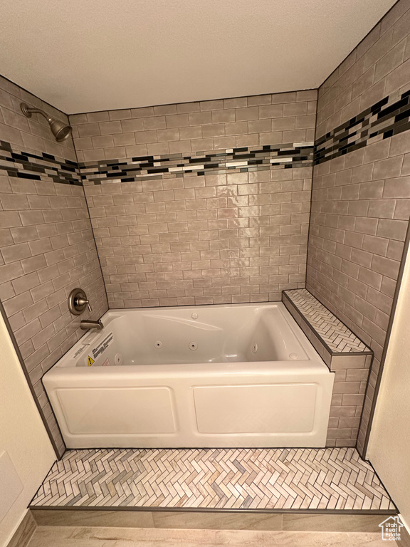 Full bath with a combined bath / shower with jetted tub