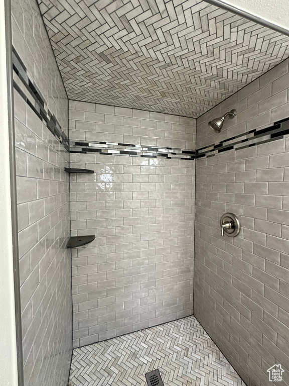 Full bath featuring a tile shower
