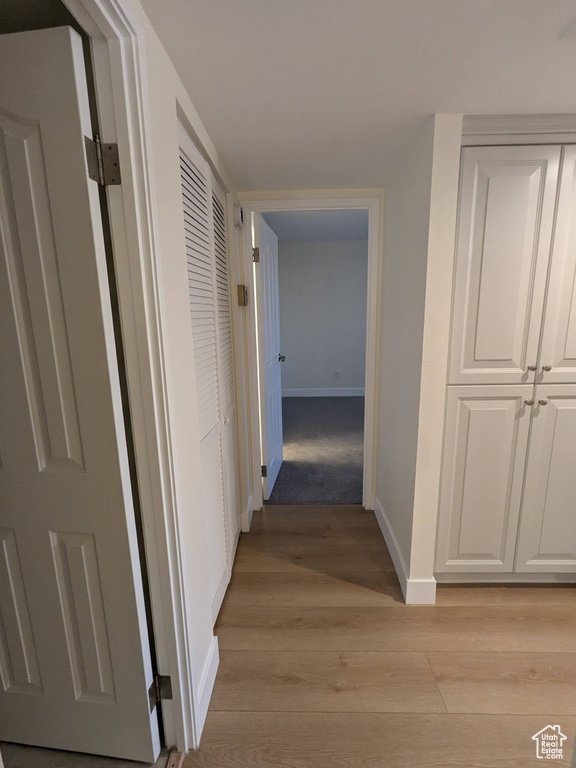 Hallway featuring baseboards and light wood-type flooring