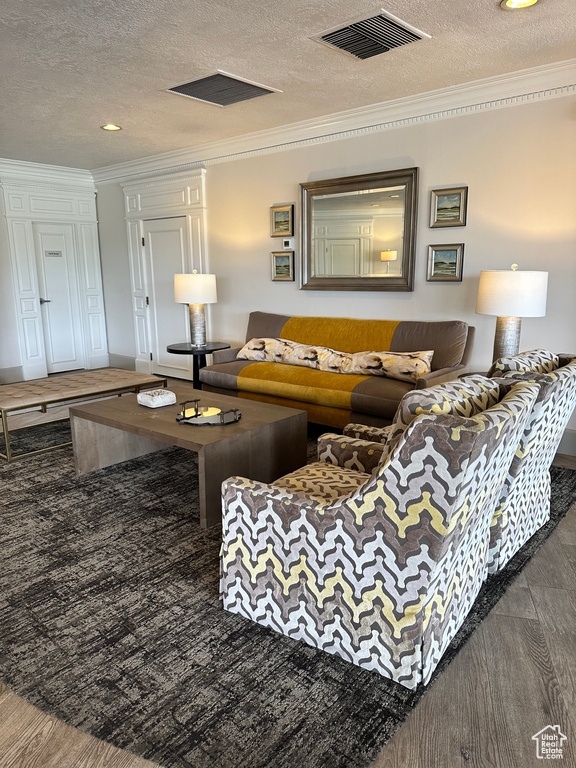 Living room with a textured ceiling and ornamental molding