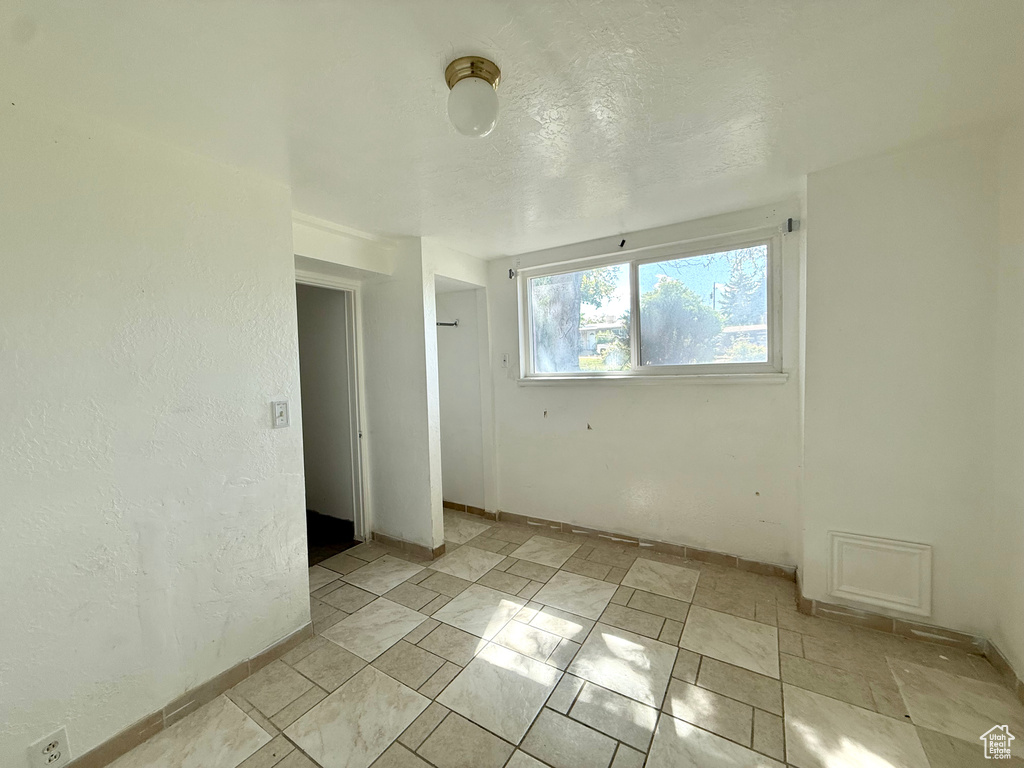 Spare room featuring baseboards