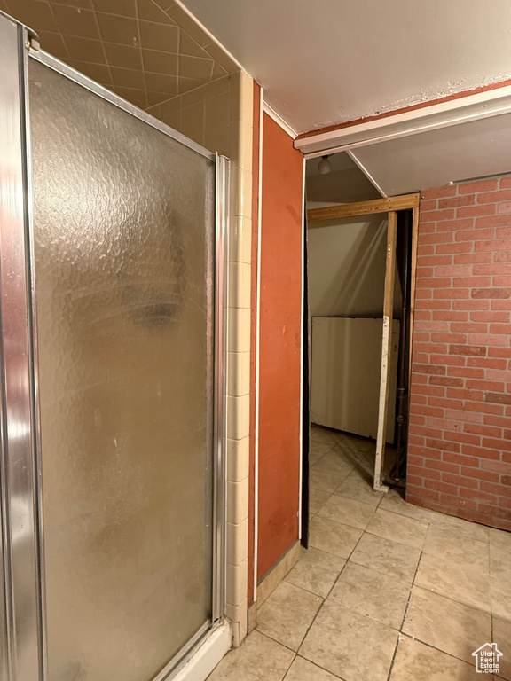 Full bathroom featuring tile patterned flooring and a shower stall