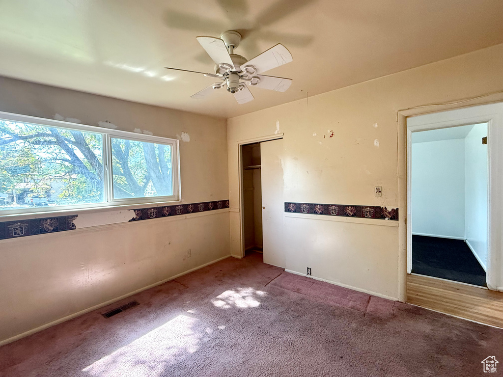 Unfurnished bedroom featuring carpet and ceiling fan