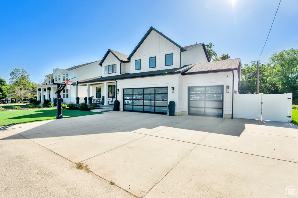 Modern farmhouse style home with board and batten siding, concrete driveway, and a garage