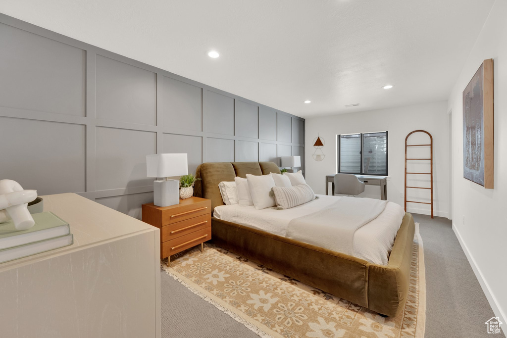 Bedroom featuring a decorative wall, carpet, recessed lighting, and baseboards