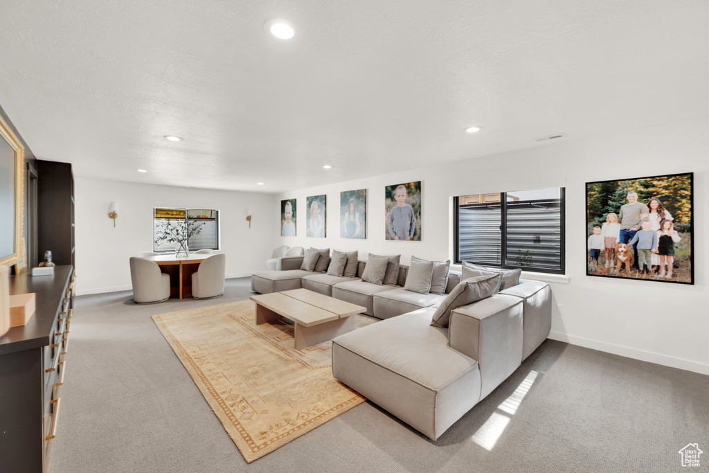 Living area with carpet, recessed lighting, and baseboards