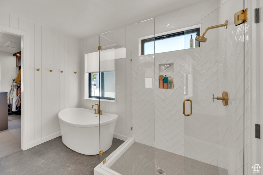 Bathroom featuring a freestanding bath and a stall shower