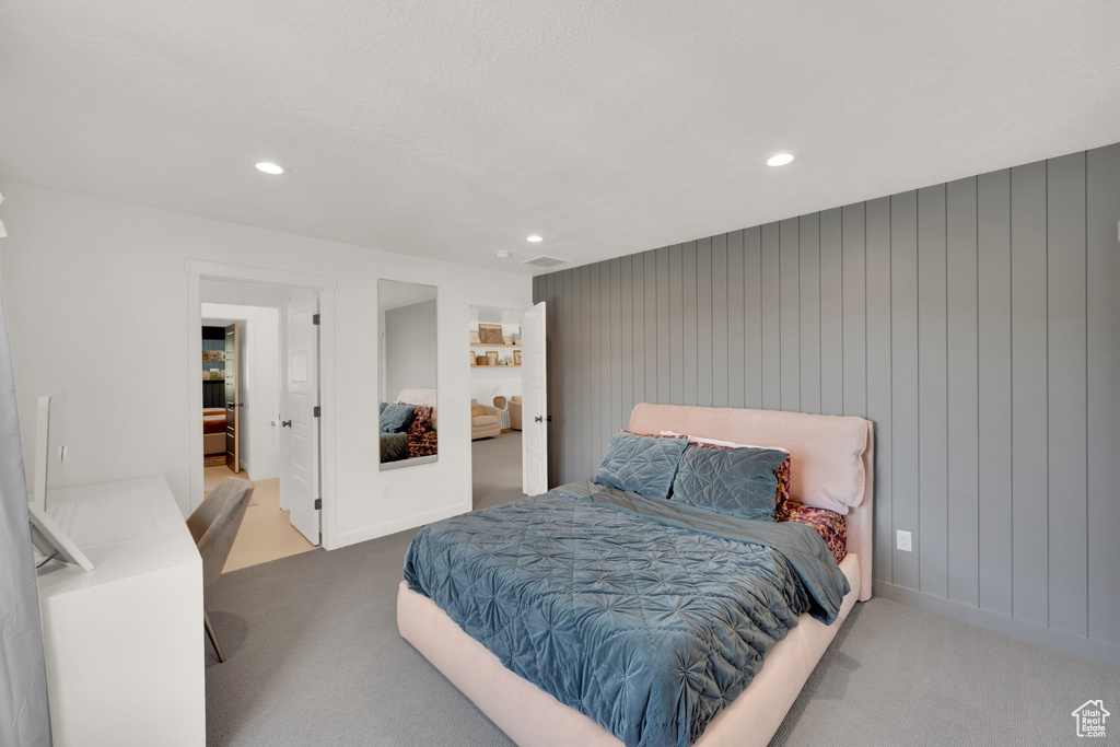 Carpeted bedroom with recessed lighting and baseboards