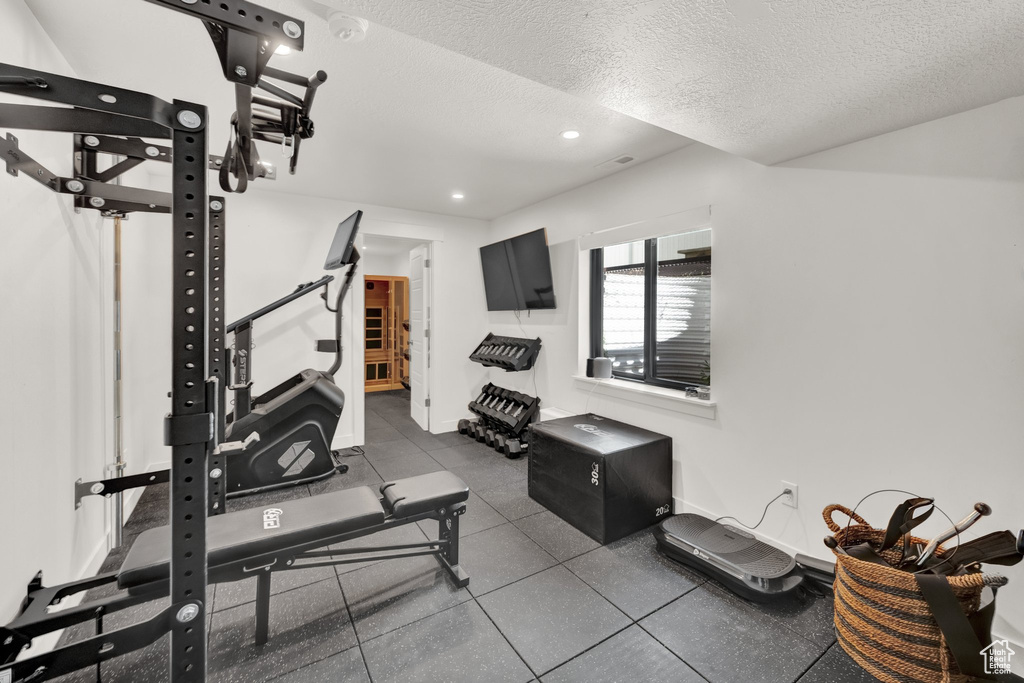 Exercise room featuring a textured ceiling and recessed lighting