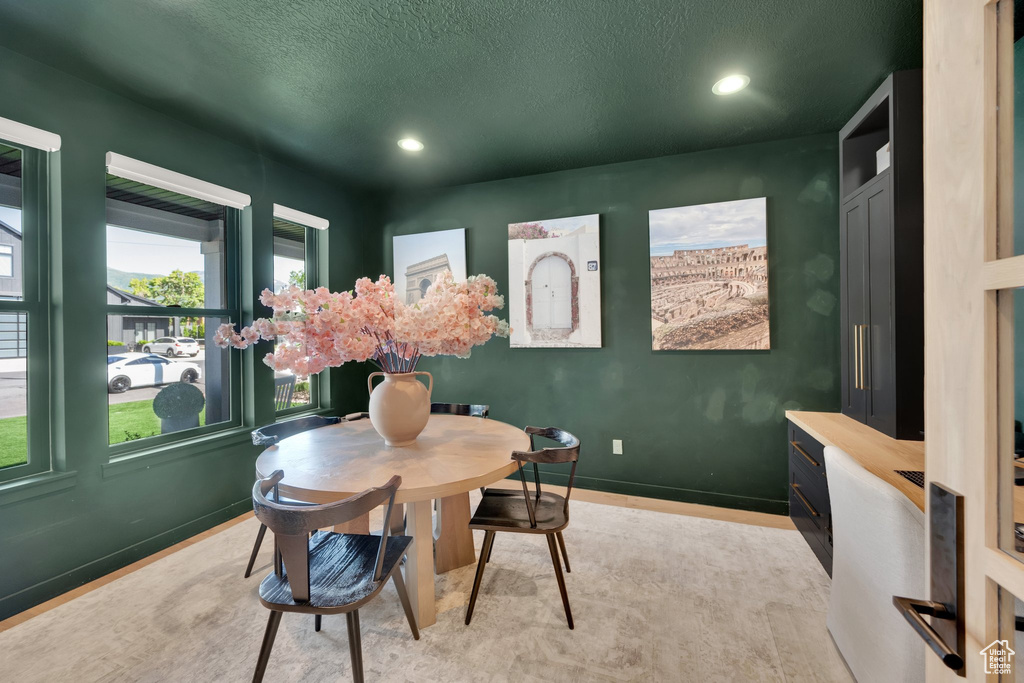 Dining space with a textured ceiling, recessed lighting, and baseboards