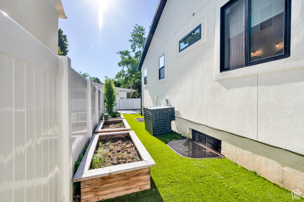 View of yard with a garden and cooling unit