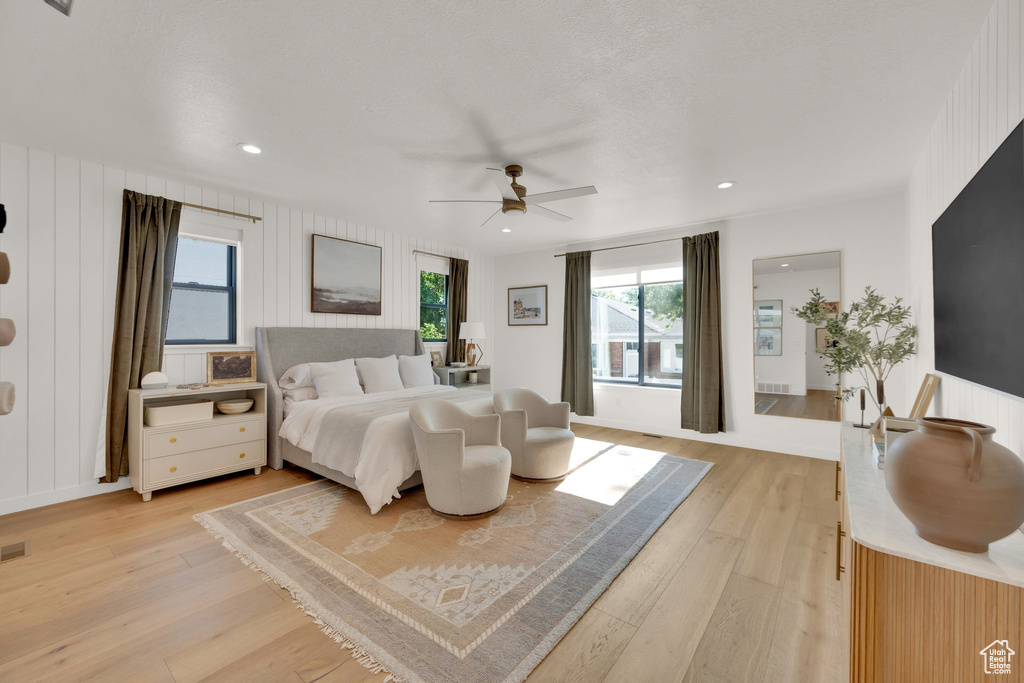 Bedroom with light wood-style flooring, a ceiling fan, and recessed lighting