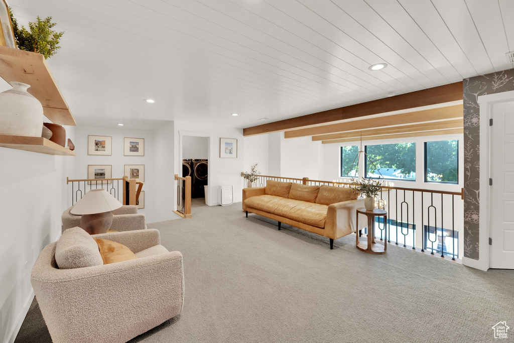 Living room featuring carpet flooring, recessed lighting, and washing machine and clothes dryer
