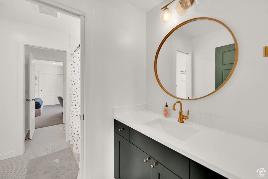Bathroom featuring vanity and baseboards
